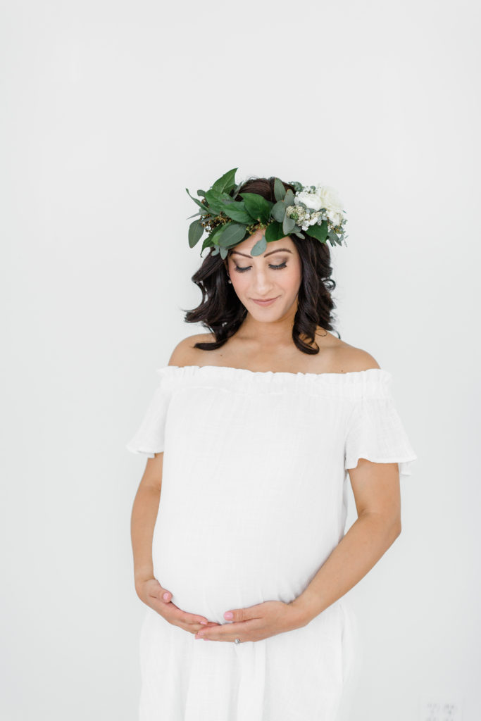 flowers, flower crown, pink blush maternity dress, white maternity dress, professional makeup, gray bench, pregnant mom, maternity session, st louis maternity, studio session, st louis family photographer, st louis photographer, st louis birth photographer, st louis maternity photographer, baby photos