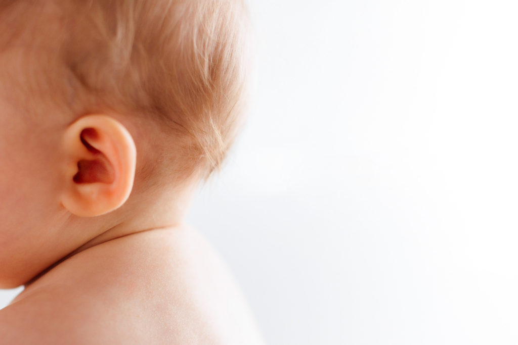 Close up of 6 month old baby's hair behind their ears. 