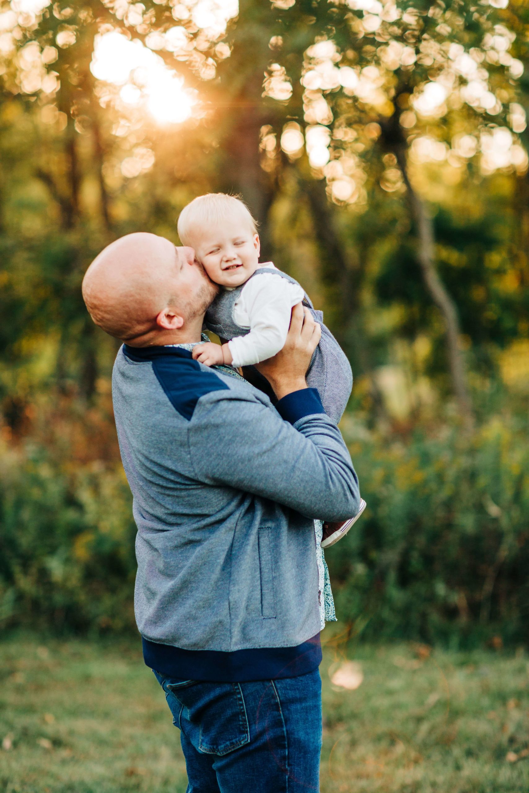 dad with toddler, first birthday session, dad kissing baby boy cheek