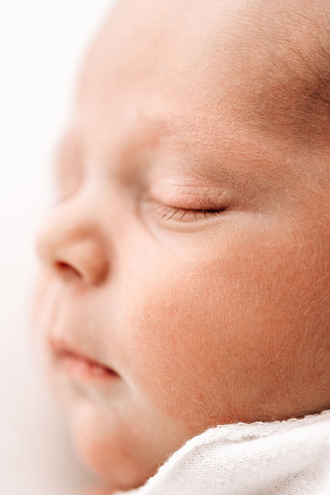 Details of a sleeping newborn baby's cheek