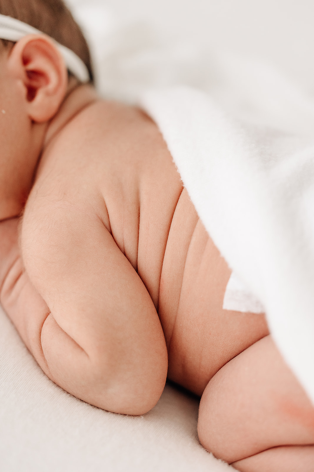 Details of a sleeping newborn baby's side rolls