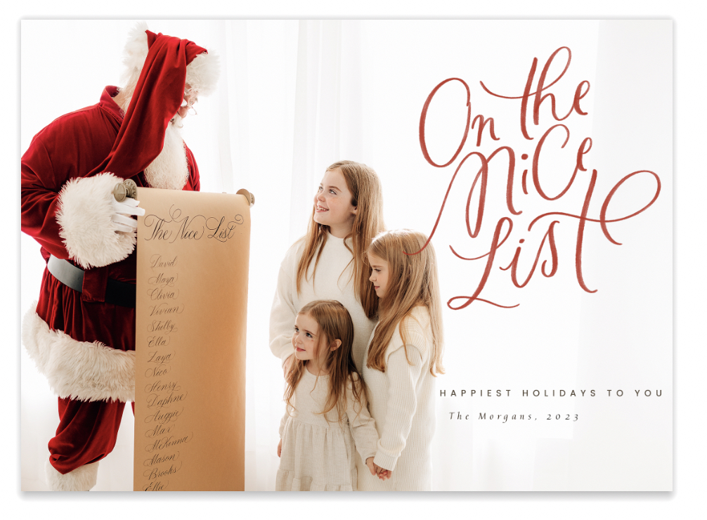 On the Nice list, three girls with Santa looking at the nice list.